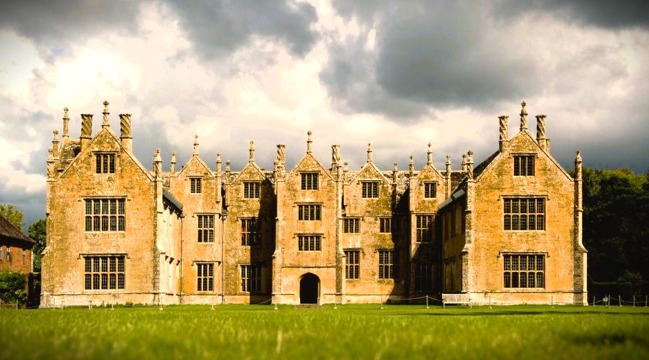 a large brick building with a lawn