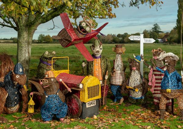 Under a tree stands the characters from The Wind in the Willows that have been woven from the willow grown at Coates English Willow.