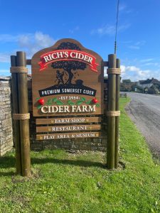 Brown wooden sign for Rich's Cider